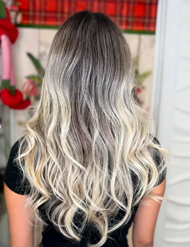 Long balayage from deep root to icy blonde ends