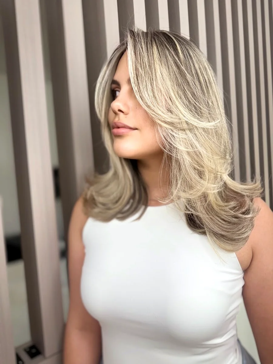 Blonde layered blowout with lived-in roots