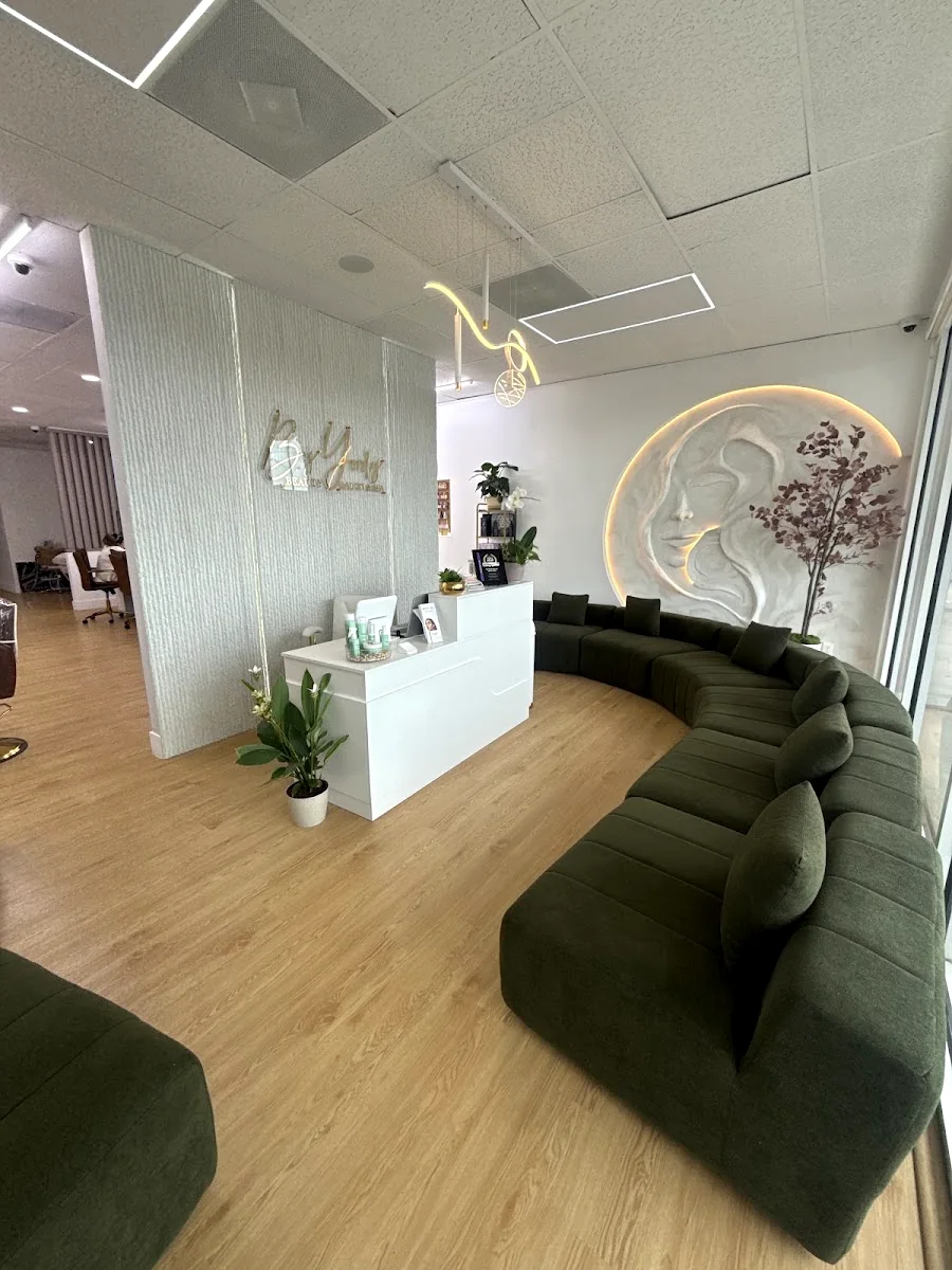 Olive velvet lounge and brass detailing inside the salon