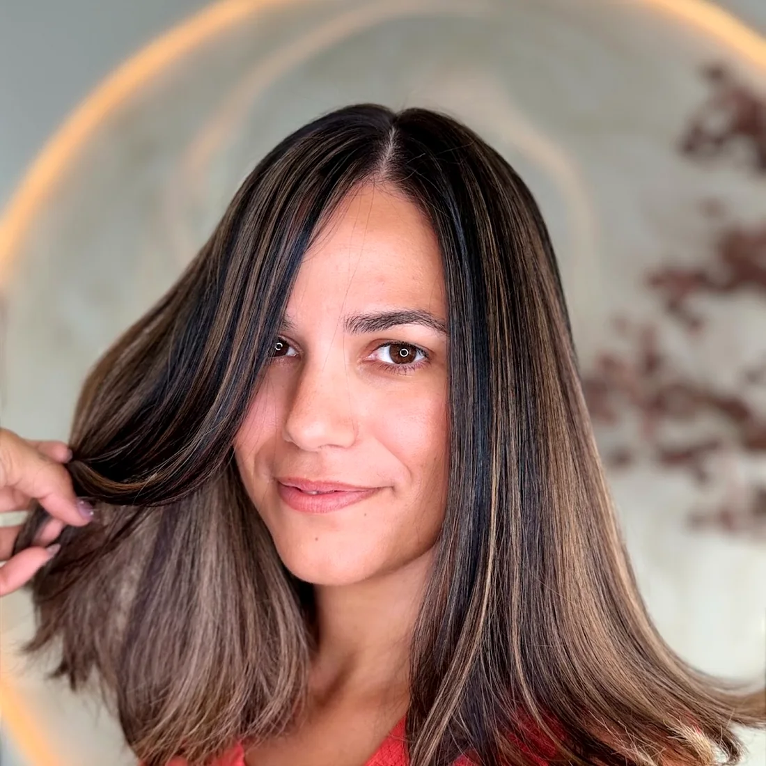 Glossy brunette finish with face-framing lights