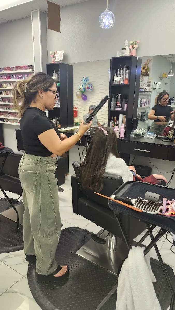 Stylist at By Yordy blow-drying a guest's hair